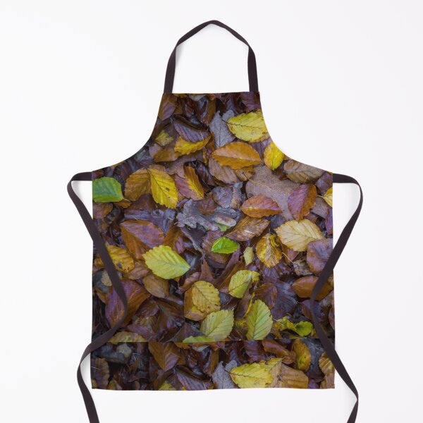 Item preview, Directly above shot of mixed autumn leaves with yellow, brown and green colors on the forest soil designed and sold by kristofbellens.