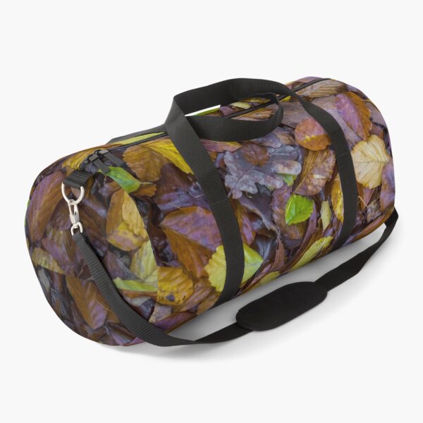 Item preview, Directly above shot of mixed autumn leaves with yellow, brown and green colors on the forest soil designed and sold by kristofbellens.