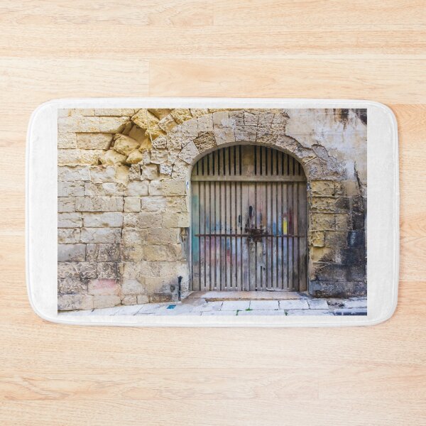 Item preview, Weathered Wooden Gate In Arched Stone Wall Of Historic Mediterranean Alleyway designed and sold by Nmallia.