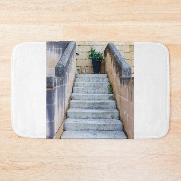 Item preview, Stone Staircase With Potted Plant Against Weathered Limestone Wall Leading Up Between Parapets designed and sold by Nmallia.