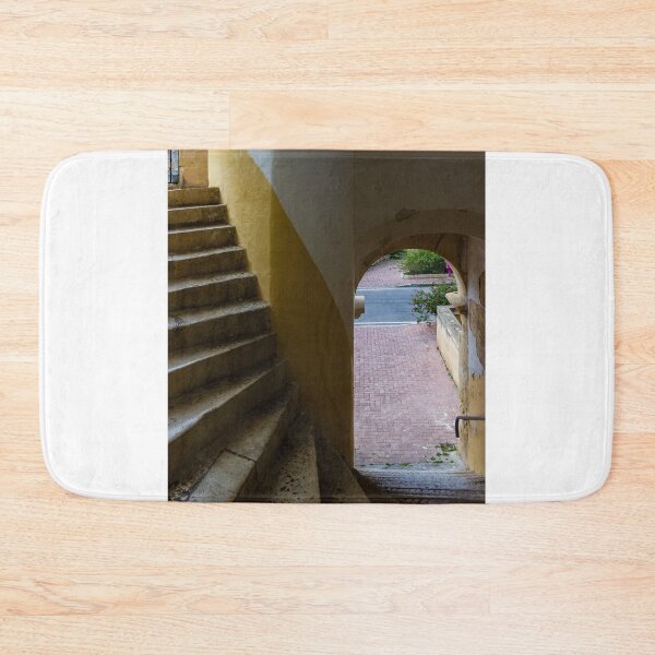 Item preview, Empty Yellow Stairwell With Worn Stone Steps And Black Metal Railing In Apartment Building designed and sold by Nmallia.