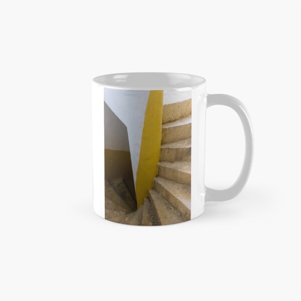 Item preview, Empty Yellow Stairwell With Worn Stone Steps And Black Metal Railing In Apartment Building designed and sold by Nmallia.