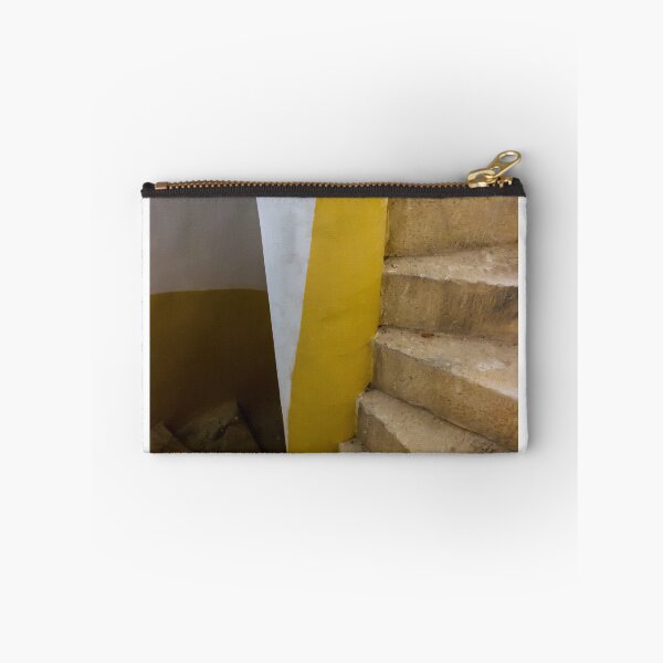 Item preview, Empty Yellow Stairwell With Worn Stone Steps And Black Metal Railing In Apartment Building designed and sold by Nmallia.