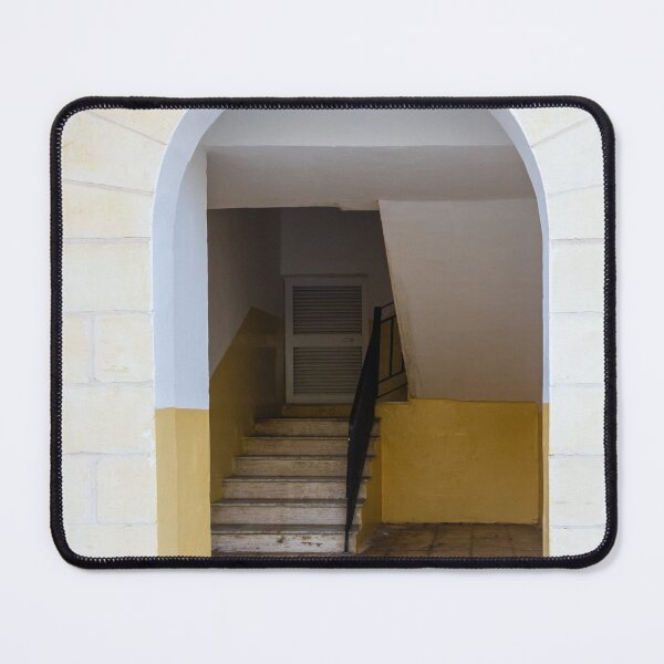 Item preview, Empty Yellow Stairwell With Worn Stone Steps And Black Metal Railing In Apartment Building designed and sold by Nmallia.