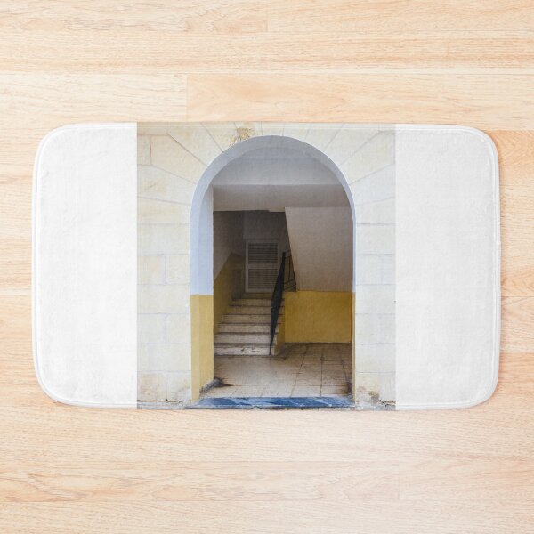 Item preview, Empty Yellow Stairwell With Worn Stone Steps And Black Metal Railing In Apartment Building designed and sold by Nmallia.