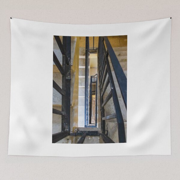 Item preview, Vertical Stairwell Perspective Looking Down Narrow Metal Railing Staircase in Apartment Building Interior designed and sold by Nmallia.