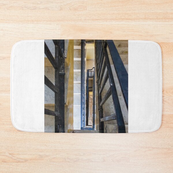 Item preview, Vertical Stairwell Perspective Looking Down Narrow Metal Railing Staircase in Apartment Building Interior designed and sold by Nmallia.