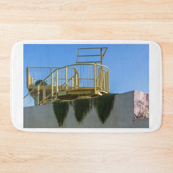 Item preview, Yellow Rooftop Observation Deck With Curved Railing and Hanging Ivy Against Blue Sky designed and sold by Nmallia.
