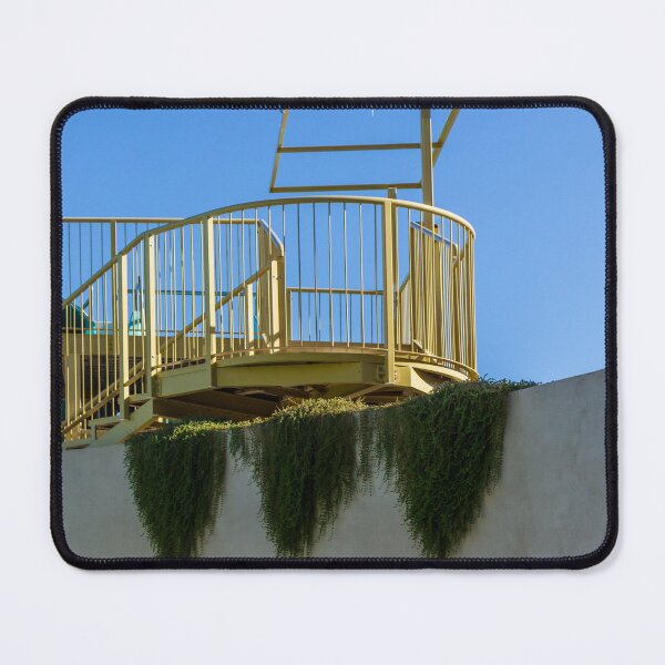 Item preview, Yellow Rooftop Observation Deck With Curved Railing and Hanging Ivy Against Blue Sky designed and sold by Nmallia.