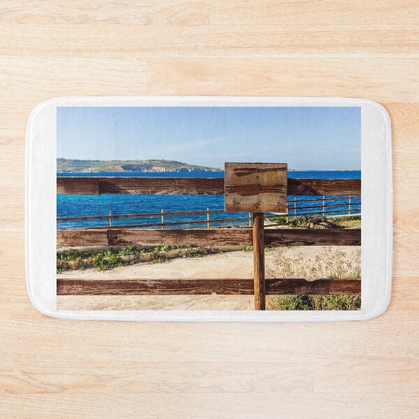 Item preview, Weathered Wooden Fence Overlooking Blue Sea and Distant Coastal Landscape on Sunny Day designed and sold by Nmallia.