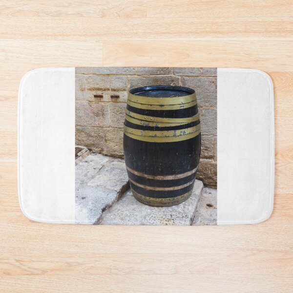 Item preview, Rustic Wooden Barrel Against Weathered Stone Wall On Old Cobblestone Street designed and sold by Nmallia.