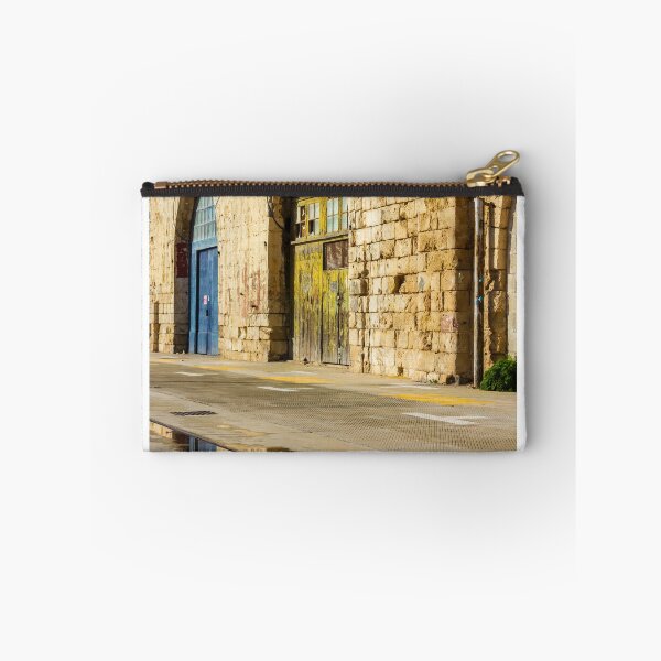 Item preview, Sunlit Old Stone Building With Arched Doors And Pavement Reflection, Weathered Yellow Door And Blue Entrance On Sunny Street designed and sold by Nmallia.