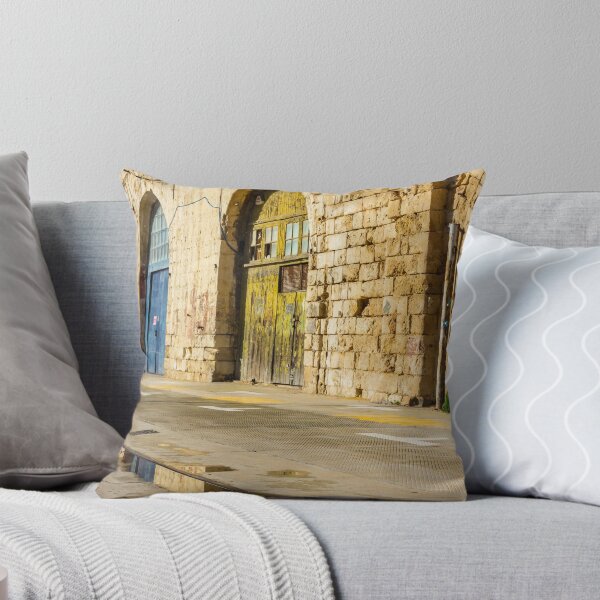 Item preview, Sunlit Old Stone Building With Arched Doors And Pavement Reflection, Weathered Yellow Door And Blue Entrance On Sunny Street designed and sold by Nmallia.