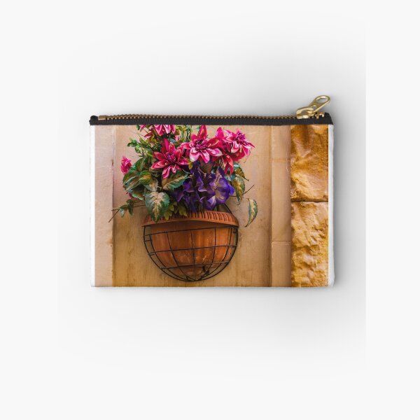 Item preview, Pink And Purple Flowers In Terracotta Wall Planter Pot Against Textured Beige Stucco Wall designed and sold by Nmallia.