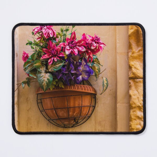 Item preview, Pink And Purple Flowers In Terracotta Wall Planter Pot Against Textured Beige Stucco Wall designed and sold by Nmallia.