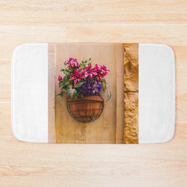 Item preview, Pink And Purple Flowers In Terracotta Wall Planter Pot Against Textured Beige Stucco Wall designed and sold by Nmallia.