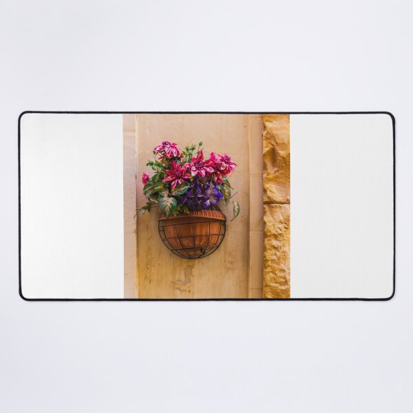 Item preview, Pink And Purple Flowers In Terracotta Wall Planter Pot Against Textured Beige Stucco Wall designed and sold by Nmallia.