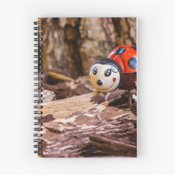 Item preview, Decorative Ladybug Figurine Amid Wooden Chips and Natural Outdoor Setting designed and sold by Nmallia.