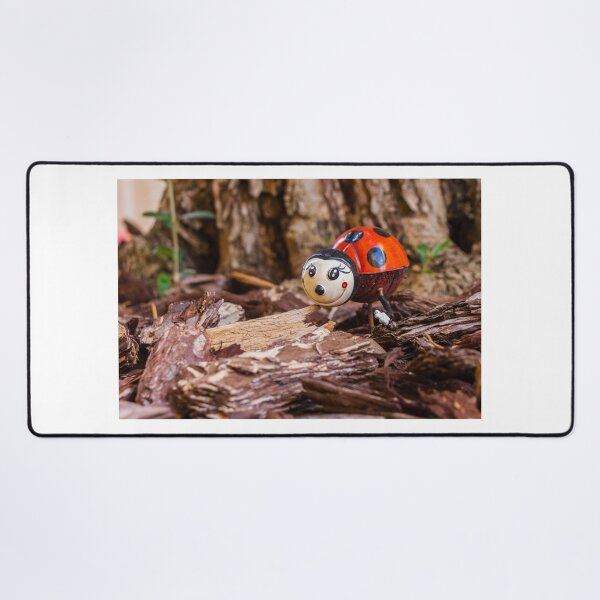 Item preview, Decorative Ladybug Figurine Amid Wooden Chips and Natural Outdoor Setting designed and sold by Nmallia.