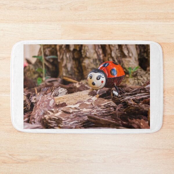 Item preview, Decorative Ladybug Figurine Amid Wooden Chips and Natural Outdoor Setting designed and sold by Nmallia.