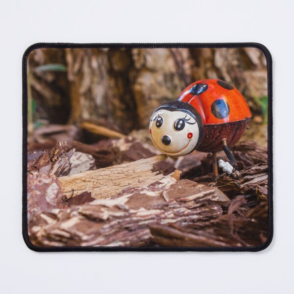 Item preview, Decorative Ladybug Figurine Amid Wooden Chips and Natural Outdoor Setting designed and sold by Nmallia.
