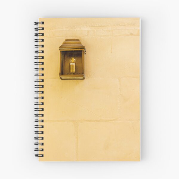 Item preview, Vintage Wall Lantern Closeup On Warm Stone Wall, Minimal Exterior Lighting And Architectural Texture designed and sold by Nmallia.