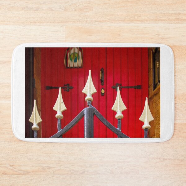 Item preview, Decorative Iron Gate With Gold Finials Guarding a Bright Red Wooden Door Entrance of Historic Home designed and sold by Nmallia.