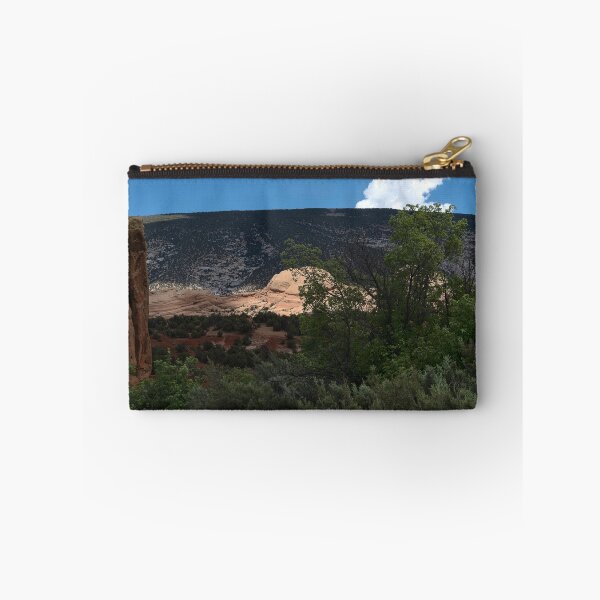 Item preview, Dinosaur National Monument formation bathed in sun spotlight amidst trees designed and sold by lisavonbiela.