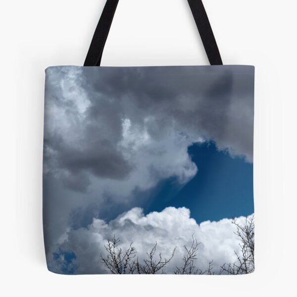 Item preview, Bare treetops silhouetted against massive cumulus clouds with trails designed and sold by lisavonbiela.