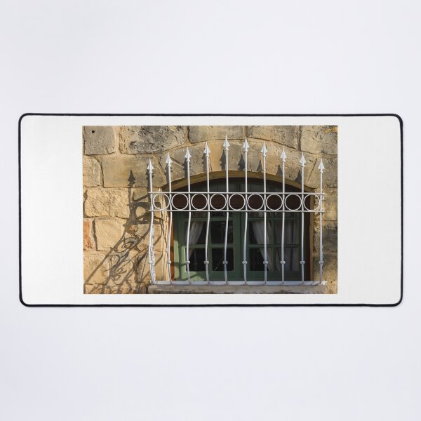 Item preview, Green Arched Window With Decorative White Wrought Iron Bars On Rustic Stone Wall In Sunlight designed and sold by Nmallia.