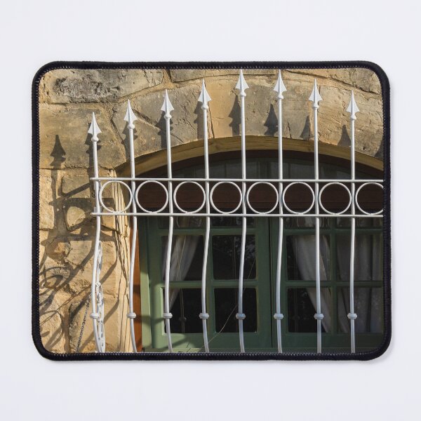 Item preview, Green Arched Window With Decorative White Wrought Iron Bars On Rustic Stone Wall In Sunlight designed and sold by Nmallia.