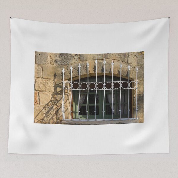 Item preview, Green Arched Window With Decorative White Wrought Iron Bars On Rustic Stone Wall In Sunlight designed and sold by Nmallia.