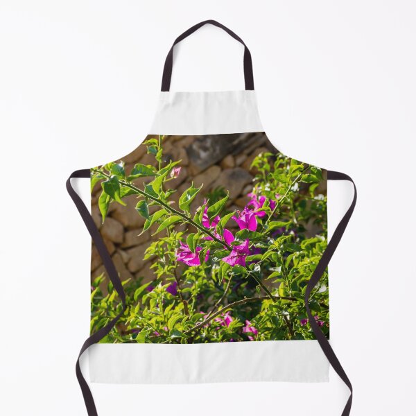 Item preview, Sunlit Pink Bougainvillea Blossoms Against Rustic Stone Wall With Lush Green Leaves Outdoor Garden Branches designed and sold by Nmallia.