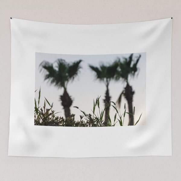Item preview, Silhouetted Coastal Grasses With Blurred Palm Trees At Dusk Sky, Tropical Sunset Mood designed and sold by Nmallia.