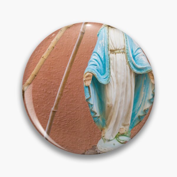 Item preview, Statue Of The Virgin Mary In Blue Robe Standing On Tree Stump Against Terracotta Wall designed and sold by Nmallia.