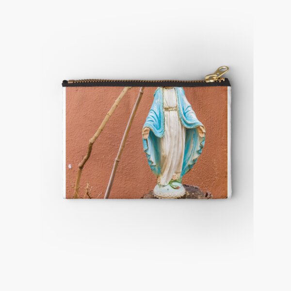 Item preview, Statue Of The Virgin Mary In Blue Robe Standing On Tree Stump Against Terracotta Wall designed and sold by Nmallia.