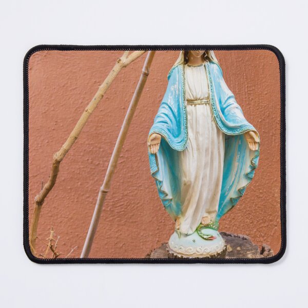 Item preview, Statue Of The Virgin Mary In Blue Robe Standing On Tree Stump Against Terracotta Wall designed and sold by Nmallia.