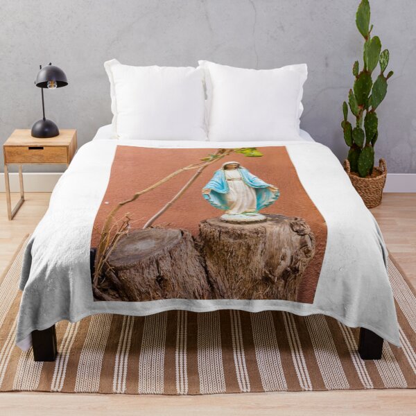 Item preview, Statue Of The Virgin Mary In Blue Robe Standing On Tree Stump Against Terracotta Wall designed and sold by Nmallia.