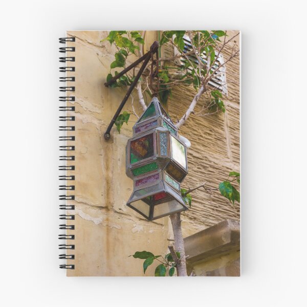 Item preview, Colorful Vintage Stained Glass Lantern Hanging On Rustic Wall With Green Vines In Alley designed and sold by Nmallia.