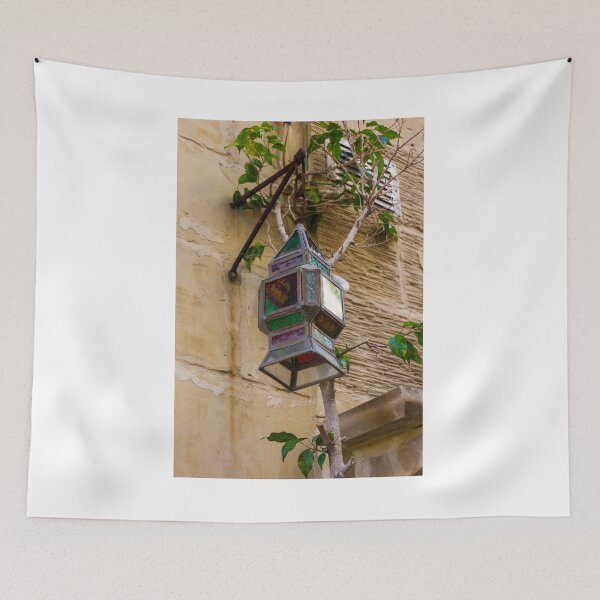 Item preview, Colorful Vintage Stained Glass Lantern Hanging On Rustic Wall With Green Vines In Alley designed and sold by Nmallia.