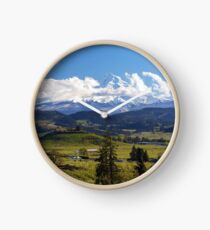 Moutn Hood with rolling clouds over fruit farm orchards in Hood River OR Clock