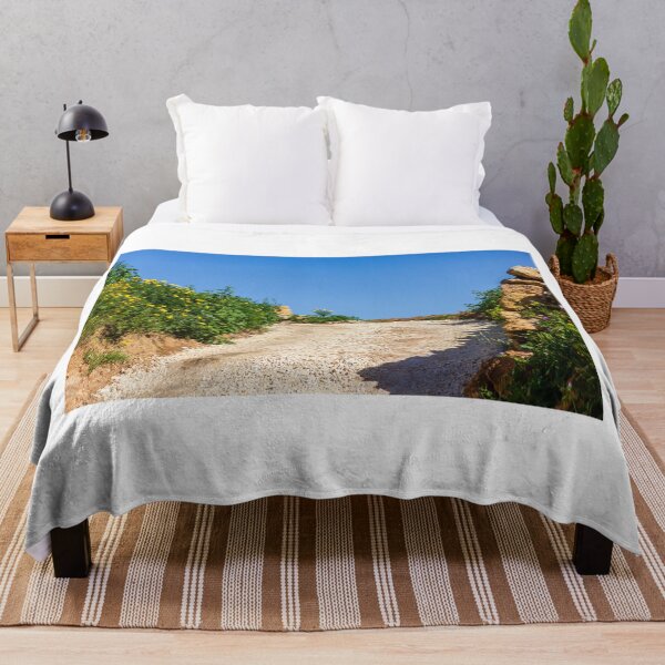 Item preview, Sunny Rural Gravel Road Lined With Yellow Wildflowers And Stone Walls Under Clear Blue Sky designed and sold by Nmallia.