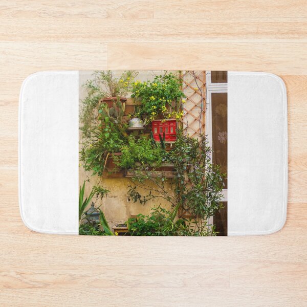 Item preview, Lush Vertical Garden With Yellow Flowers, Potted Plants And Rustic Window Trellis On Stone Wall designed and sold by Nmallia.
