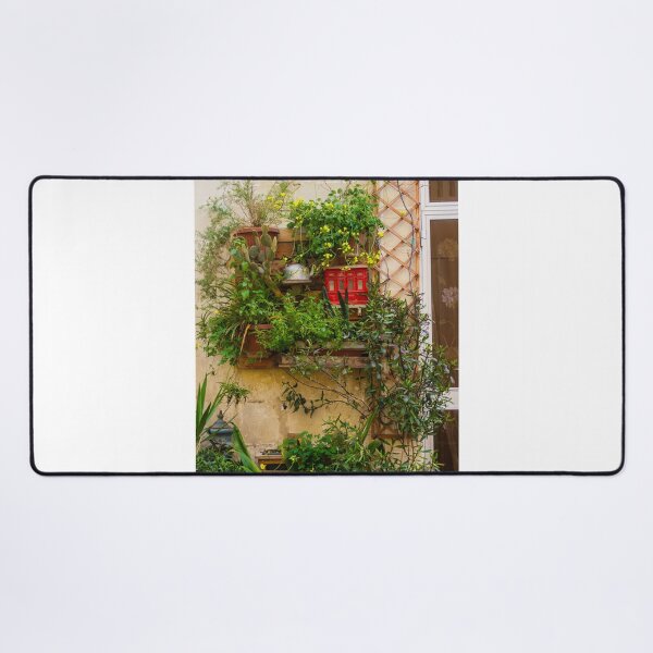 Item preview, Lush Vertical Garden With Yellow Flowers, Potted Plants And Rustic Window Trellis On Stone Wall designed and sold by Nmallia.