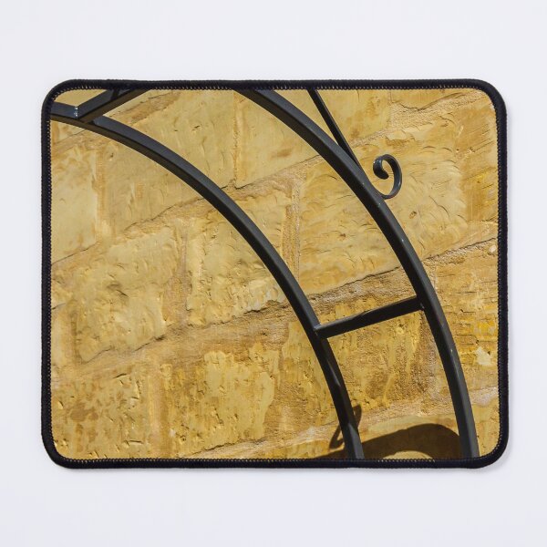 Item preview, Decorative Wrought Iron Arch Casting Shadow On Sunlit Sandstone Wall Architectural Detail designed and sold by Nmallia.