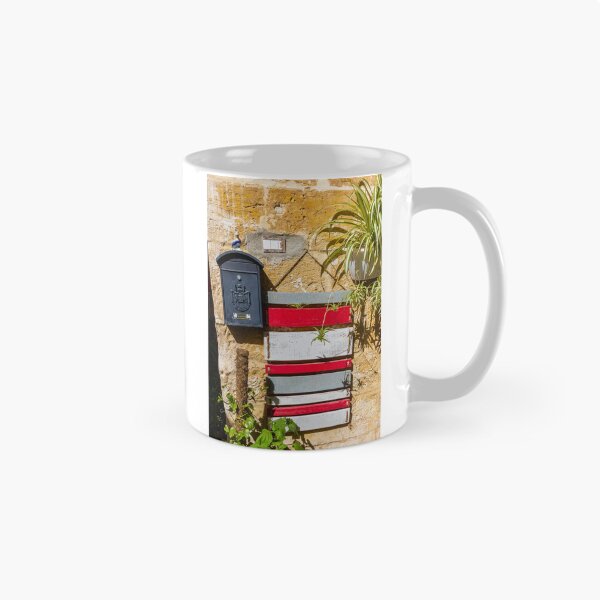 Item preview, Rustic Black Mailbox On Sunlit Stone Wall With Red And White Wooden Panels And Potted Plant designed and sold by Nmallia.