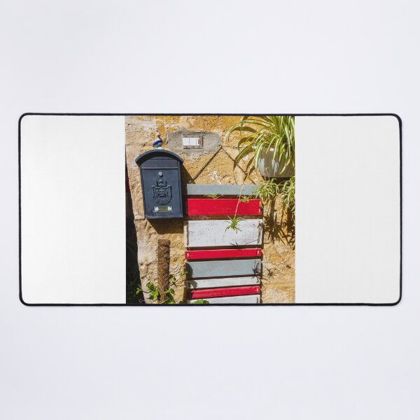 Item preview, Rustic Black Mailbox On Sunlit Stone Wall With Red And White Wooden Panels And Potted Plant designed and sold by Nmallia.