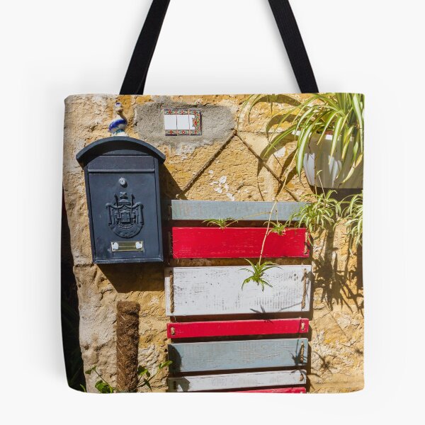 Item preview, Rustic Black Mailbox On Sunlit Stone Wall With Red And White Wooden Panels And Potted Plant designed and sold by Nmallia.