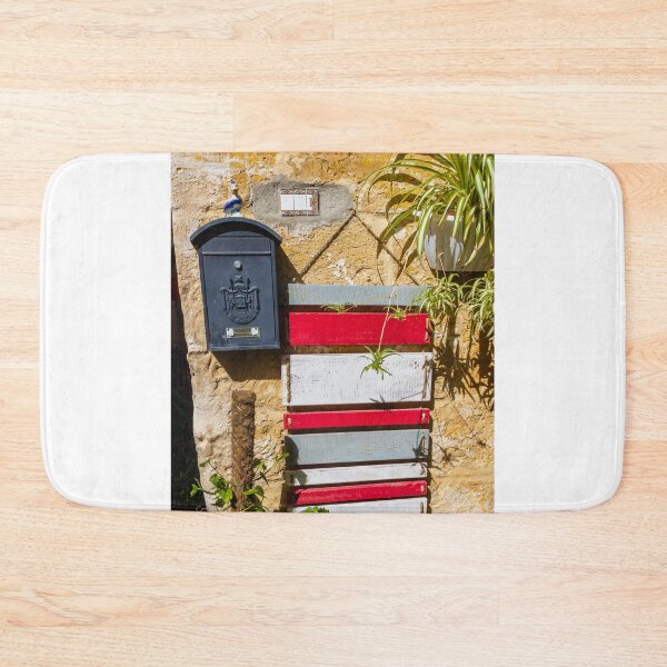 Item preview, Rustic Black Mailbox On Sunlit Stone Wall With Red And White Wooden Panels And Potted Plant designed and sold by Nmallia.