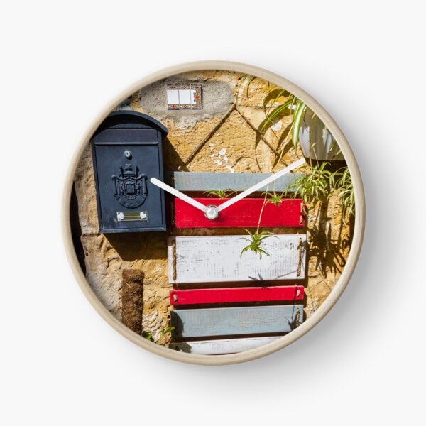 Item preview, Rustic Black Mailbox On Sunlit Stone Wall With Red And White Wooden Panels And Potted Plant designed and sold by Nmallia.